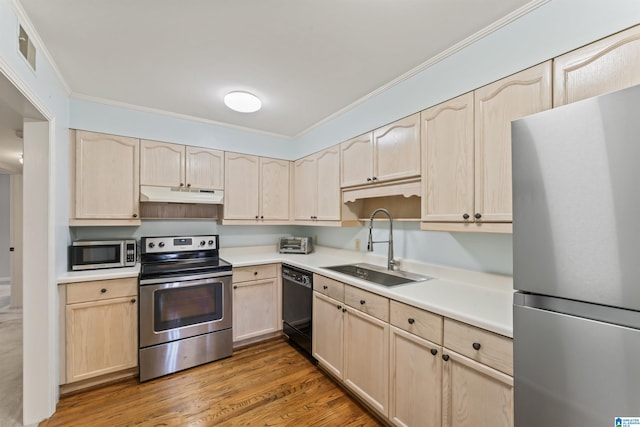 kitchen with a sink, under cabinet range hood, light brown cabinetry, and stainless steel appliances