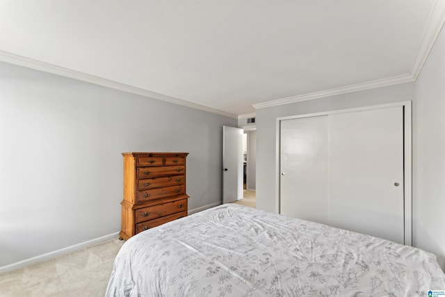 bedroom with visible vents, ornamental molding, a closet, baseboards, and light colored carpet