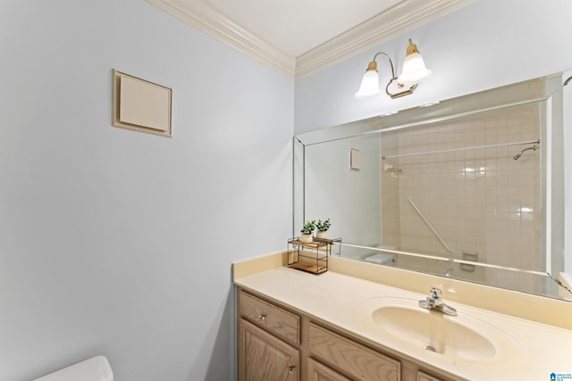 bathroom featuring vanity, toilet, tiled shower, and ornamental molding