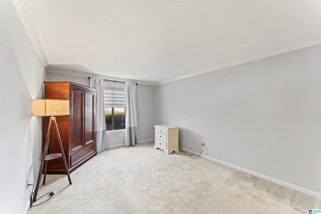 unfurnished bedroom featuring ornamental molding, baseboards, and light carpet