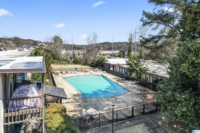 pool featuring a patio area and fence