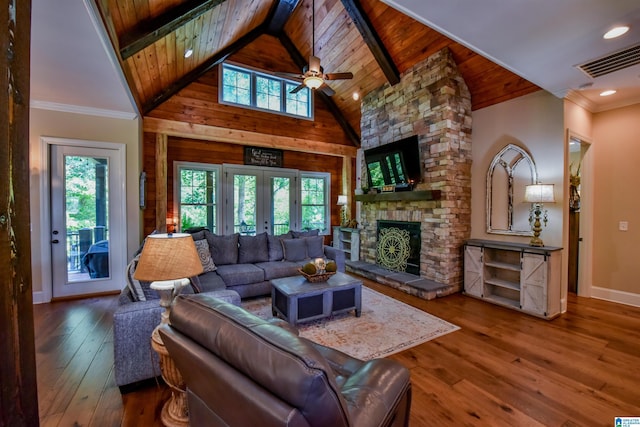 living area featuring visible vents, a healthy amount of sunlight, and hardwood / wood-style flooring