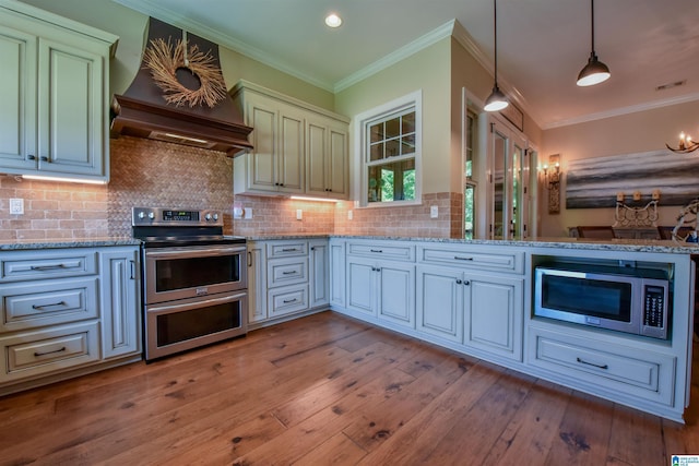 kitchen with custom exhaust hood, light wood-style flooring, ornamental molding, stainless steel appliances, and tasteful backsplash