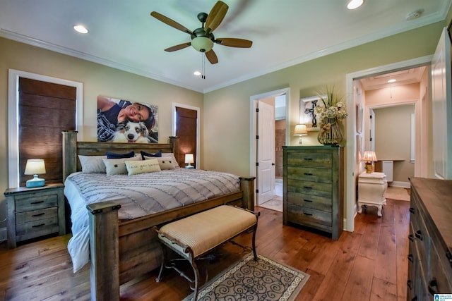 bedroom featuring hardwood / wood-style floors, attic access, recessed lighting, and crown molding