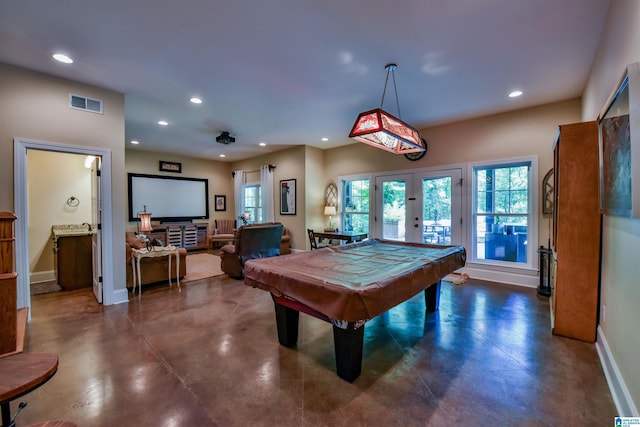 game room featuring french doors, plenty of natural light, visible vents, and finished concrete flooring