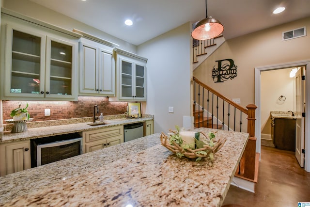 kitchen featuring finished concrete flooring, a sink, decorative backsplash, wine cooler, and stainless steel dishwasher