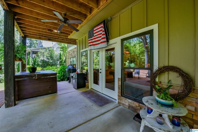 view of patio / terrace featuring a hot tub and ceiling fan