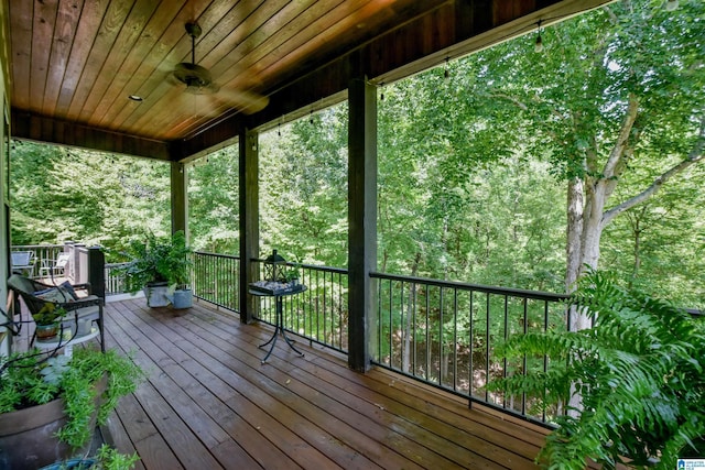 wooden terrace featuring a ceiling fan