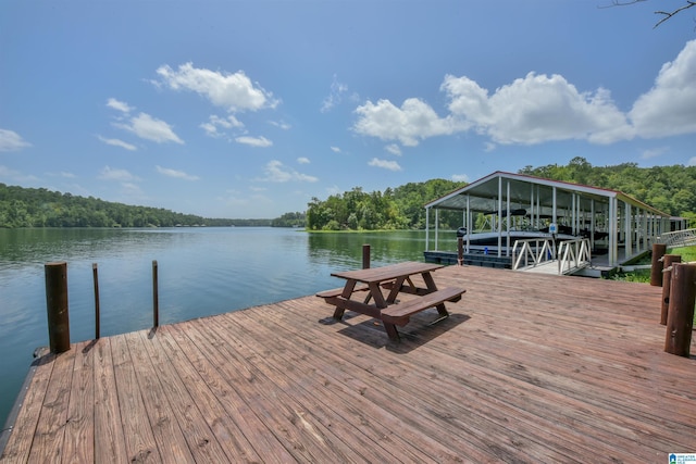 dock area with a view of trees and a water view