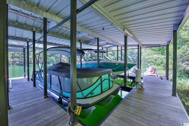 dock area with a water view and boat lift