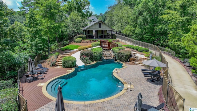 view of swimming pool with a fenced in pool, a patio, stairs, and fence