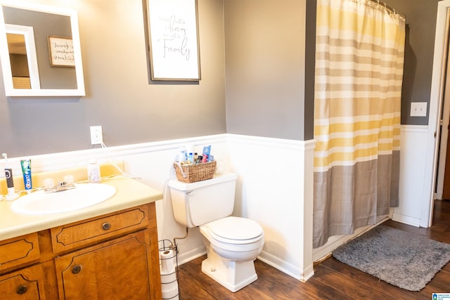 full bathroom featuring vanity, a shower with curtain, toilet, and wood finished floors