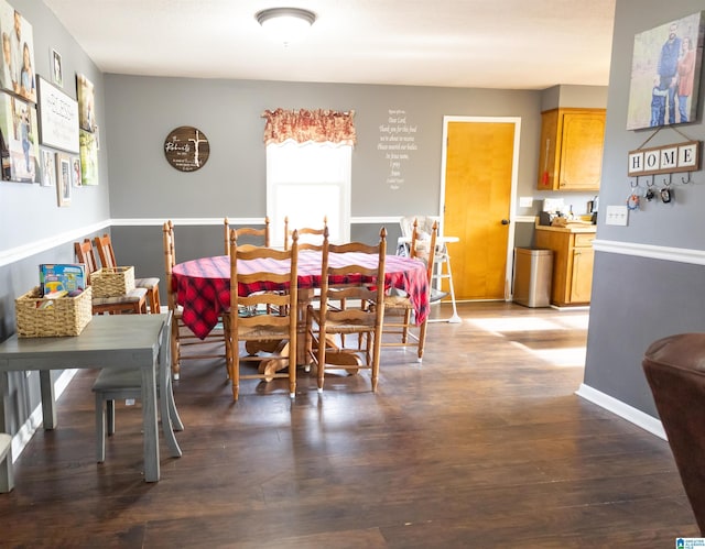 dining room with baseboards and wood finished floors