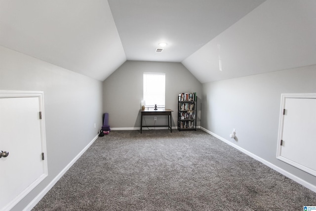 additional living space with carpet flooring, baseboards, and lofted ceiling