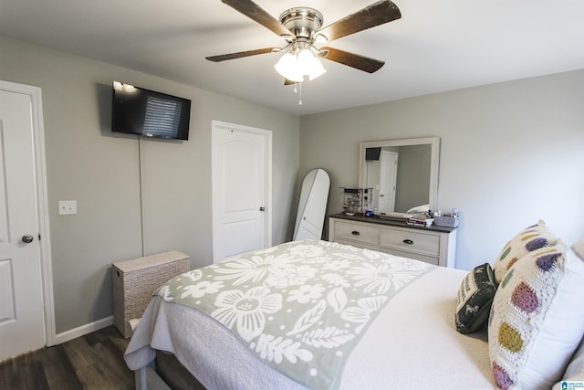 bedroom featuring ceiling fan, a closet, baseboards, and dark wood finished floors