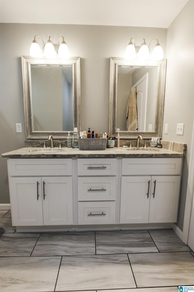 full bathroom with double vanity and a sink