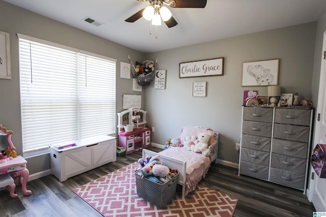 bedroom with dark wood-type flooring, multiple windows, baseboards, and visible vents