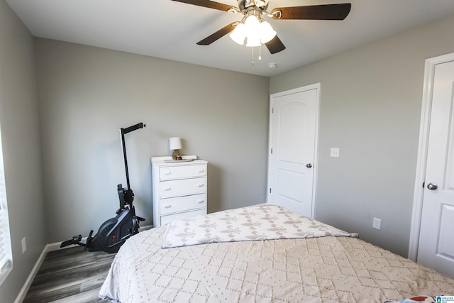 bedroom with baseboards, ceiling fan, and wood finished floors