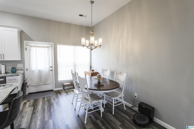 dining space with visible vents, baseboards, a chandelier, and dark wood-style flooring