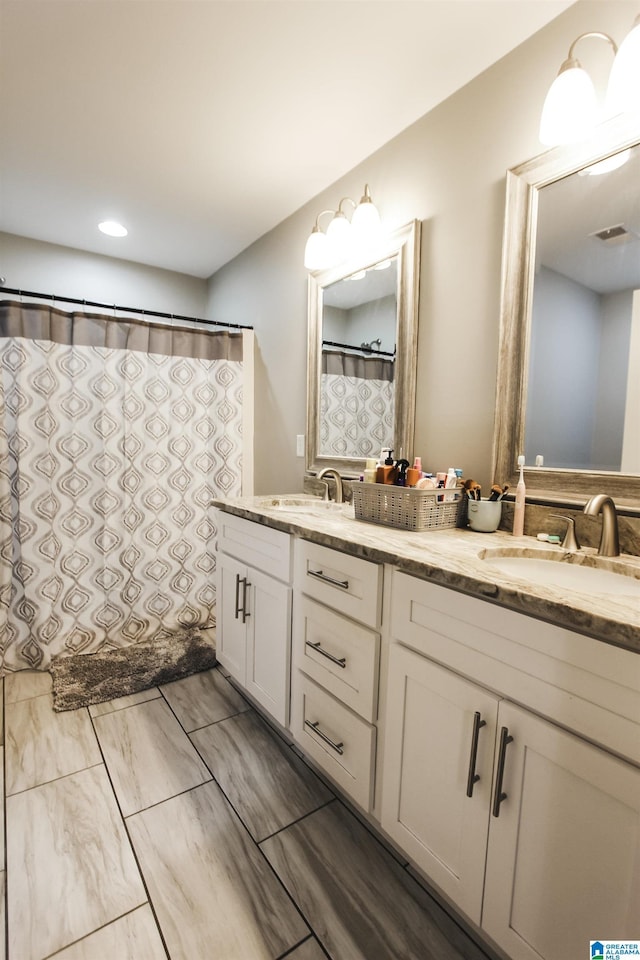 bathroom featuring a sink, visible vents, and double vanity