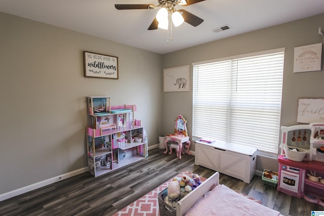 recreation room featuring visible vents, ceiling fan, baseboards, and dark wood-style flooring