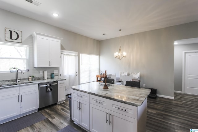 kitchen with visible vents, a sink, stainless steel dishwasher, dark wood finished floors, and white cabinetry