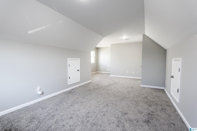 bonus room with baseboards, carpet, and lofted ceiling