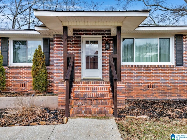 property entrance with brick siding