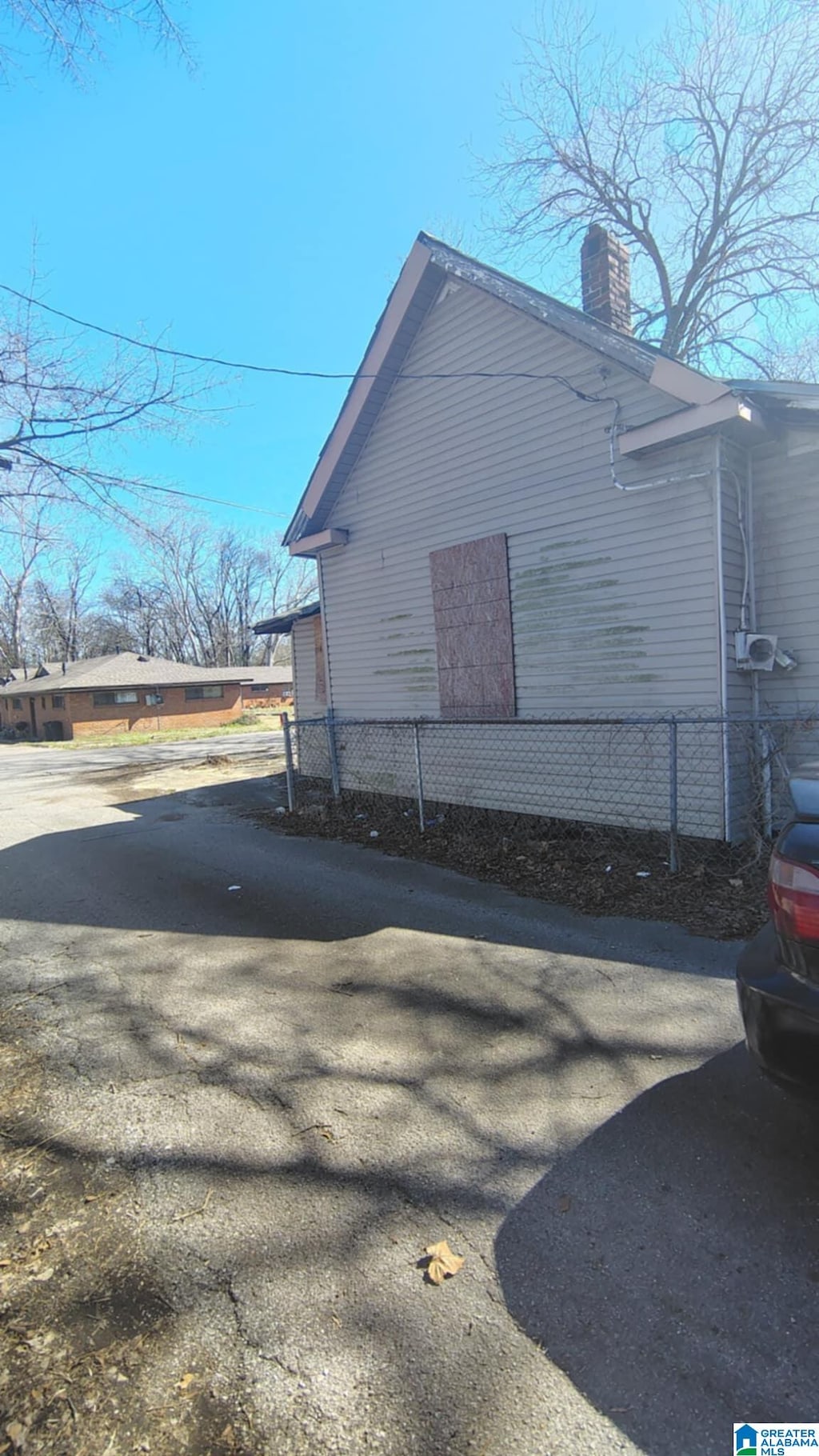 view of home's exterior with fence and a chimney