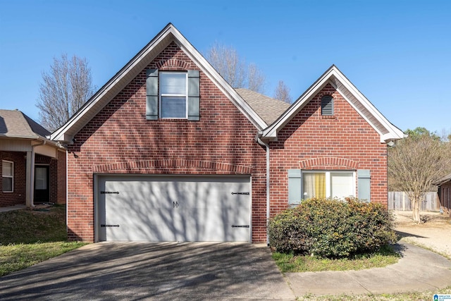 traditional-style house featuring brick siding, an attached garage, driveway, and roof with shingles