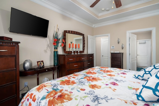 bedroom featuring a raised ceiling, ceiling fan, and ornamental molding