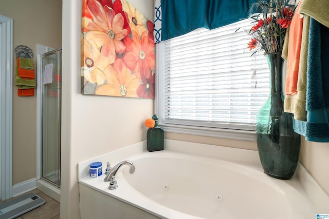 bathroom featuring a shower stall, a jetted tub, and tile patterned floors