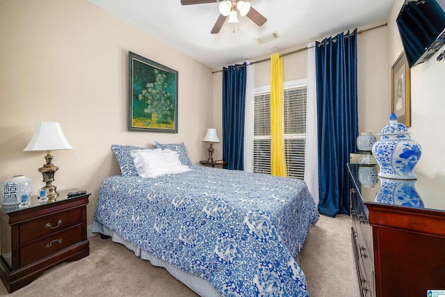 carpeted bedroom with visible vents and ceiling fan