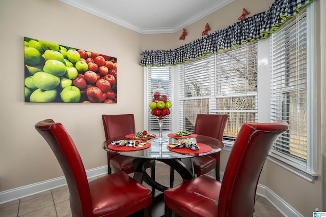 dining space with baseboards, ornamental molding, and tile patterned flooring