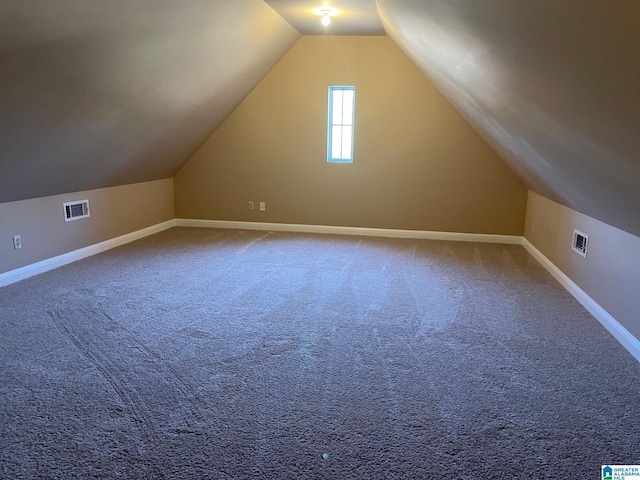 bonus room featuring baseboards, visible vents, carpet floors, and lofted ceiling