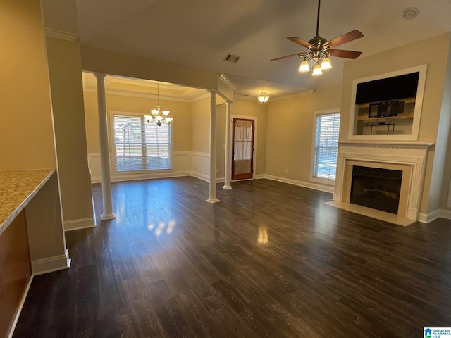 unfurnished living room with a fireplace with flush hearth, visible vents, plenty of natural light, and ornate columns