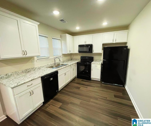 kitchen featuring visible vents, white cabinetry, black appliances, and a sink