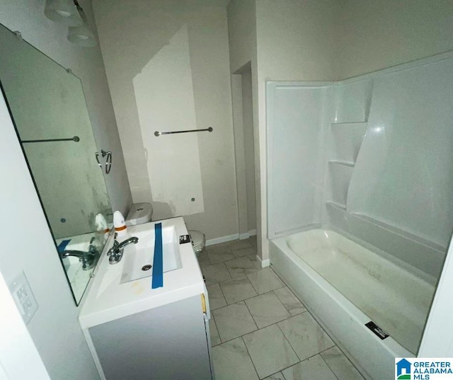 full bathroom with vanity, shower / bathing tub combination, baseboards, and marble finish floor