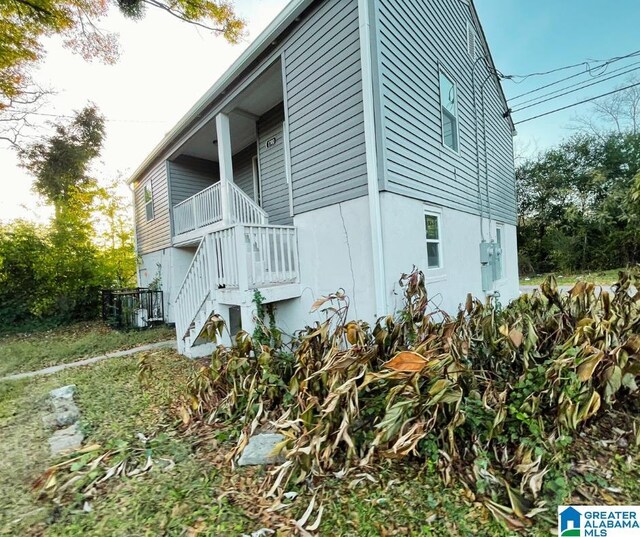 view of home's exterior with stairway and stucco siding