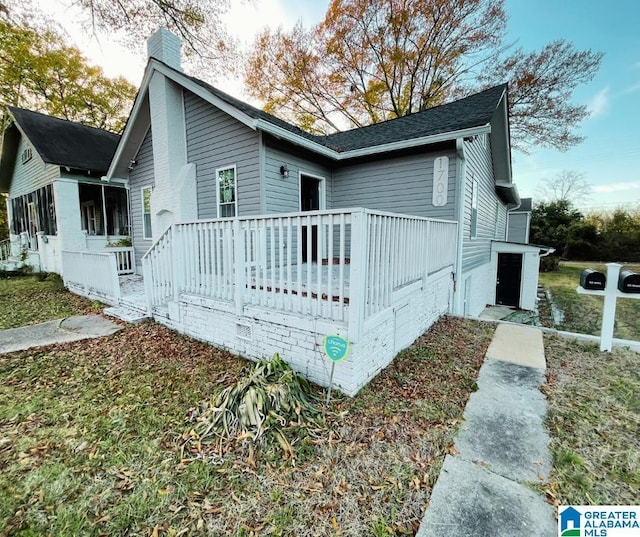 exterior space with a deck and a chimney