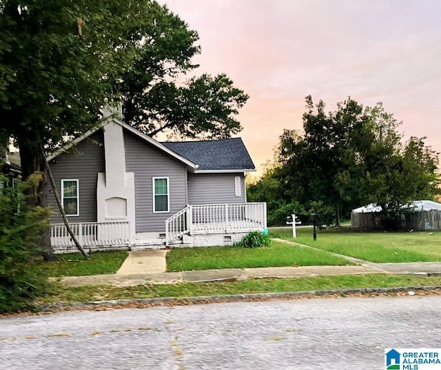 bungalow-style home with a front yard