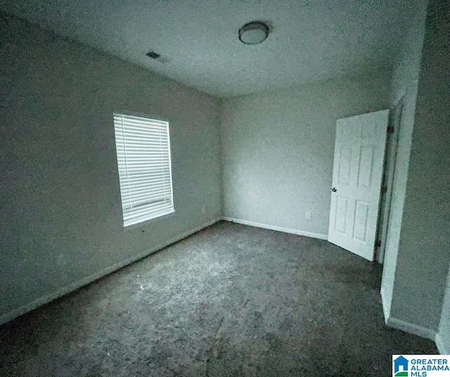 unfurnished bedroom featuring visible vents, baseboards, and carpet