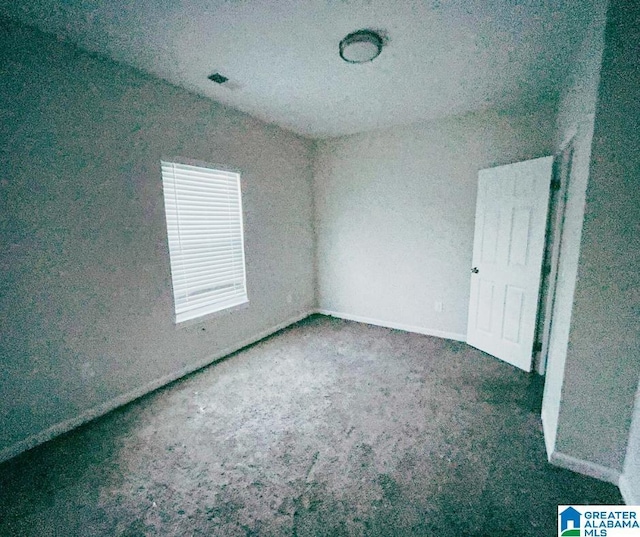 unfurnished bedroom with carpet, visible vents, and baseboards