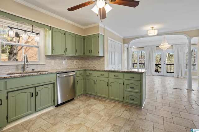 kitchen featuring a sink, dishwasher, ornate columns, and green cabinetry