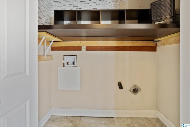 laundry room featuring stone finish floor, laundry area, hookup for a washing machine, and baseboards