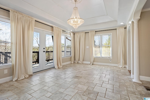 spare room featuring a tray ceiling, french doors, baseboards, and a chandelier