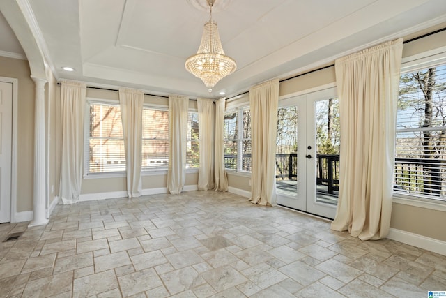 unfurnished sunroom with a chandelier, visible vents, french doors, and a raised ceiling