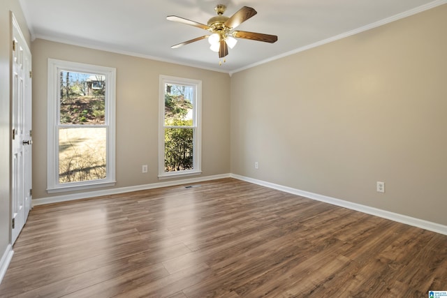 unfurnished room featuring baseboards, a ceiling fan, wood finished floors, and crown molding