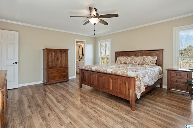 bedroom featuring light wood finished floors, multiple windows, baseboards, and ornamental molding