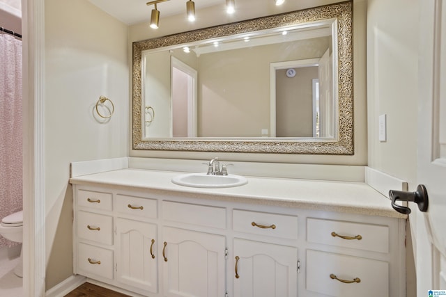 full bath featuring vanity and toilet